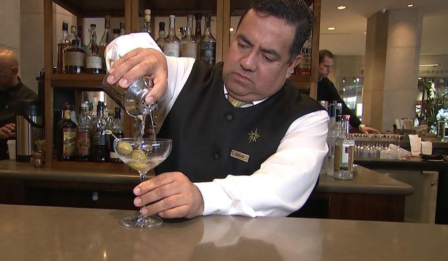This Jan. 3, 2017 image taken from video shows Beverly Hilton hotel bartender Oscar Zuleta mixing drinks at the hotel in Beverly Hills, Calif. Zuleta has toasted with Sean Connery, gotten a head rub from Tom Hanks, shared a selfie with Jessica Alba while working previous Golden Globe Awards. The 48-year-old hotel staffer keeps the drinks flowing at the awards circuit&#39;s booziest gathering. (AP Photo/Rick Taber)