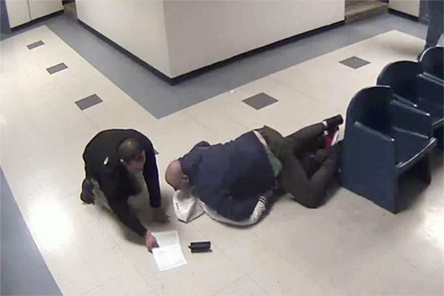This Jan. 28, 2014 still image from jail surveillance video, provided by attorney Matthew Hoppock, shows two immigration agents in an altercation with Justine Mochama, an international student from Kenya who overstayed his visa, for refusing to be fingerprinted before deportation at the Butler County Detention Facility in El Dorado, Kan. Mochama filed a lawsuit alleging he was violently attacked by the agents and won a rare legal victory Tuesday, Jan. 3, 2017, when a federal judge ruled that his lawsuit could go to trial over the incident captured on jailhouse surveillance video. (Butler County Detention Facility surveillance video provided by attorney Matthew Hoppock via AP)