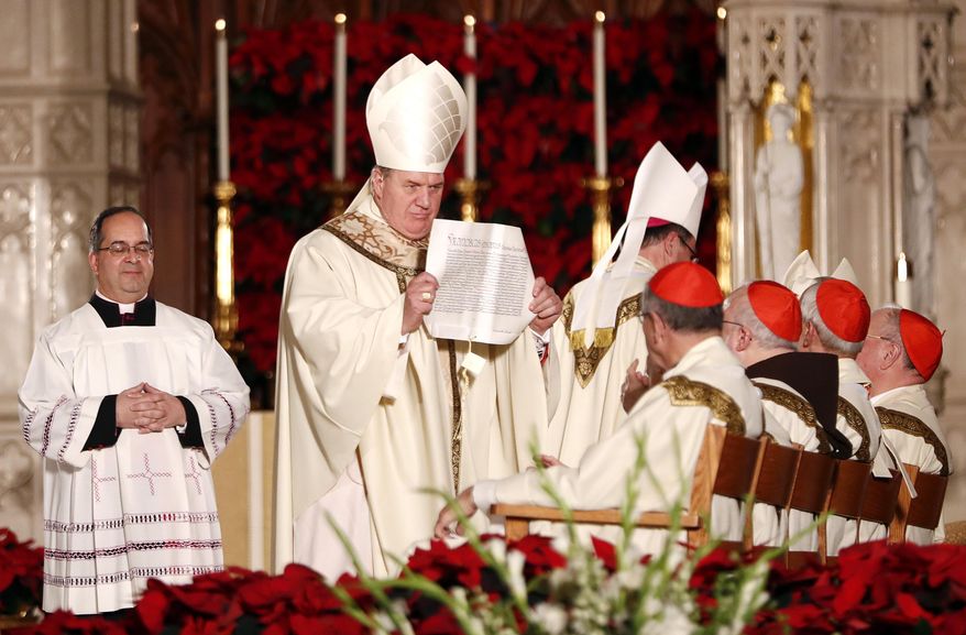 Joseph Cardinal Tobin, center, shows a declaration read by Christopher Pierre, apostolic nuncio of the United States, which installed Tobin as the new archbishop of Newark, N.J., during a Mass ceremony, Friday, Jan. 6, 2017, in Newark, N.J. Tobin succeeds Archbishop John Myers, who reached the mandatory retirement age of 75 in July. (AP Photo/Julio Cortez)