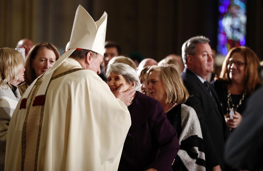 Joseph Cardinal Tobin, left, greets his mother, Marie Terese Kerwin before heading to the altar to be installed as the new archbishop of Newark, N.J., during a Mass ceremony, Friday, Jan. 6, 2017, in Newark, N.J. Tobin succeeds Archbishop John Myers, who reached the mandatory retirement age of 75 in July. (AP Photo/Julio Cortez)