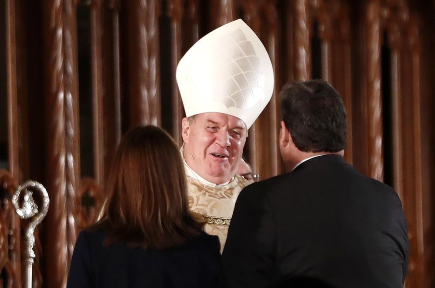 Joseph Cardinal Tobin, center, is congratulated by New Jersey Gov. Chris Christie, right, and first lady Mary Pat Christie after Tobin was installed as the new archbishop of Newark, N.J., during a Mass ceremony, Friday, Jan. 6, 2017, in Newark, N.J. Tobin succeeds Archbishop John Myers, who reached the mandatory retirement age of 75 in July. (AP Photo/Julio Cortez)