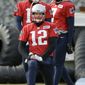 New England Patriots quarterbacks Tom Brady (12), Jimmy Garoppolo, top left, and Jacoby Brissett, top right, warm up during an NFL football practice, Thursday, Jan. 5, 2017, in Foxborough, Mass. (AP Photo/Steven Senne)