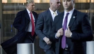 President-elect Donald Trump, left, departs a meeting at the Condé Nast offices at One World Trade Center in New York, Friday, Jan. 6, 2017. (AP Photo/Andrew Harnik)