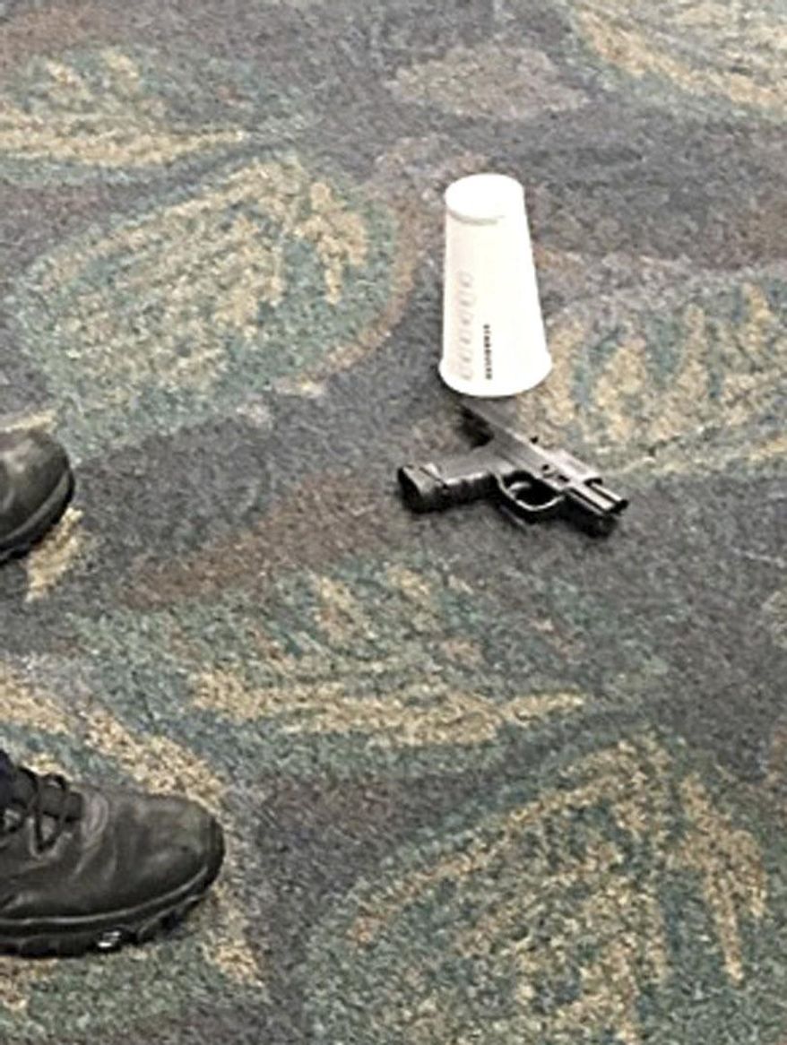In this image taken Friday, Jan. 6, 2017 and made available by Mark Lea, shows the pistol of alleged shooter Esteban Santiago at the Ft. Lauderdale-Hollywood International Airport. Santiago opened fire in the baggage claim area killing five travelers. (Mark Lea via AP)
