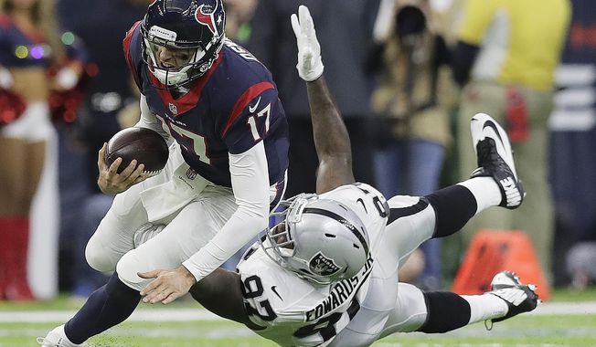 Houston Texans quarterback Brock Osweiler (17) scrambles for a first down against Oakland Raiders defensive end Mario Edwards (97) during the first half of an AFC Wild Card NFL football game Saturday, Jan. 7, 2017, in Houston. (AP Photo/Eric Gay)