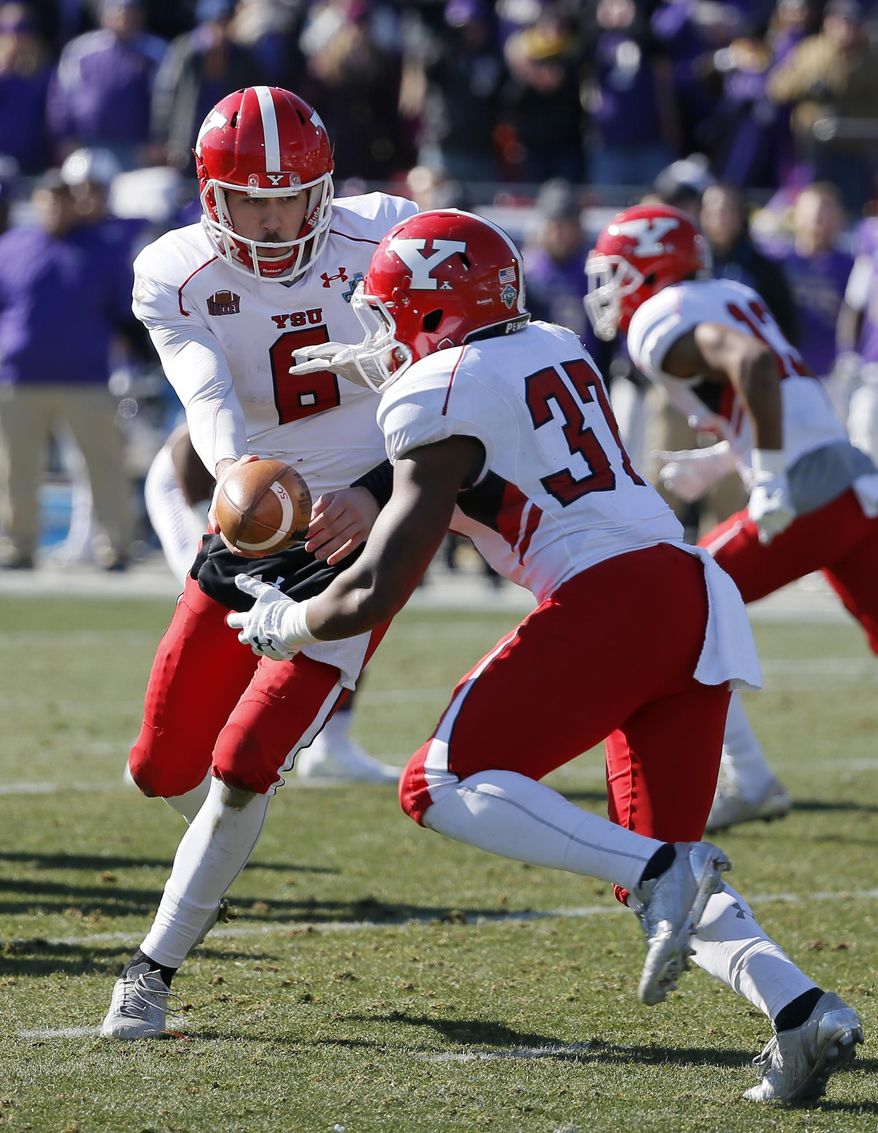 Youngstown State's Hunter Wells (6) hands the ball off to running back Tevin McCaster (37) in the first half of the FCS championship NCAA college football game against James Madison, Saturday, Jan. 7, 2017, in Frisco, Texas. (AP Photo/Tony Gutierrez)