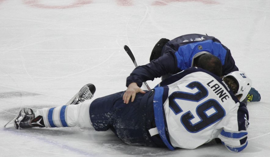 Winnipeg Jets forward Patrik Laine (29) is helped by a trainer after getting hit during the third period of an NHL hockey game against the Buffalo Sabres, Saturday, Jan. 7, 2017, in Buffalo, N.Y. (AP Photo/Jeffrey T. Barnes)