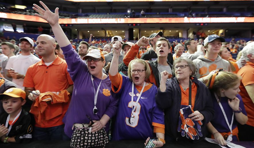 Clemson fans cheer during media day for the NCAA college football playoff championship game against Alabama Saturday, Jan. 7, 2017, in Tampa, Fla. (AP Photo/David J. Phillip)
