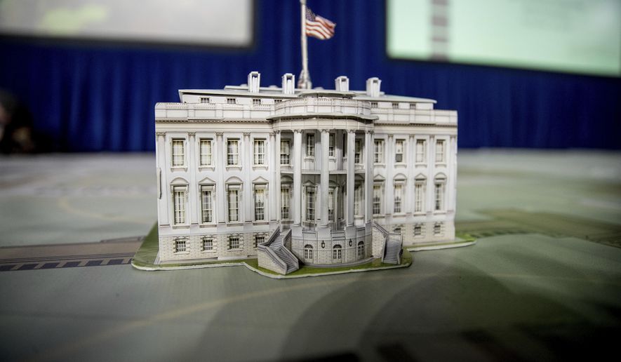 FILE - In this Dec. 14, 2016, file photo, a model of the White House is displayed on a giant planning map during a media tour highlighting inaugural preparations being made by the Joint Task Force-National Capital Region for military and civilian planners at the DC Armory in Washington. It’s typically an unquestioned honor to participate in the inauguration of an American president. This time, though, it’s different. The sharp divisions over Donald Trump’s election have politicians, celebrities and even high school students debating whether taking part in the inauguration is a political act that demonstrates support for the new president and his agenda or a nonpartisan tribute to democratic traditions and the peaceful transfer of power.(AP Photo/Andrew Harnik, File)