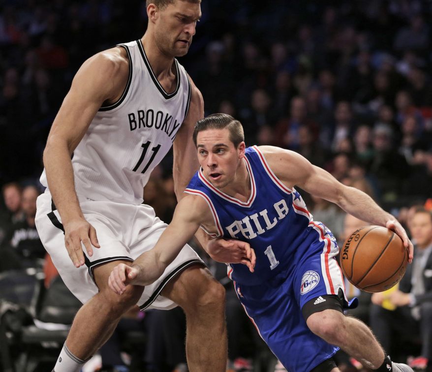 Philadelphia 76ers' T.J. McConnell, right, pushes past Brooklyn Nets' Brook Lopez during the first half of the NBA basketball game at the Barclays Center, Sunday, Jan. 8, 201,7 in New York. (AP Photo/Seth Wenig)