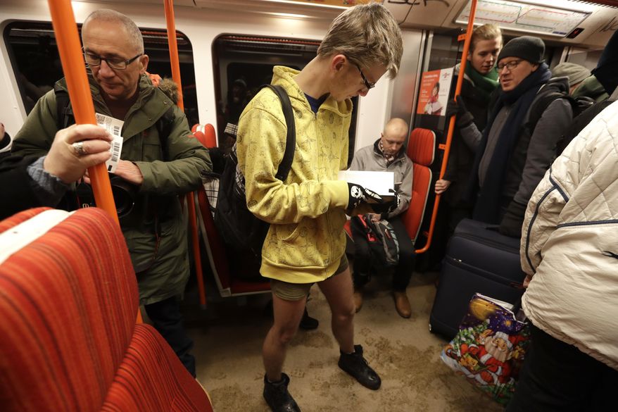 Passenger reads a book while taking part in the No Pants Subway Ride in Prague, Czech Republic, Sunday, Jan. 8, 2017. The No Pants Subway Ride began in 2002 in New York as a stunt and has taken place in cities around the world since then. (AP Photo/Petr David Josek)