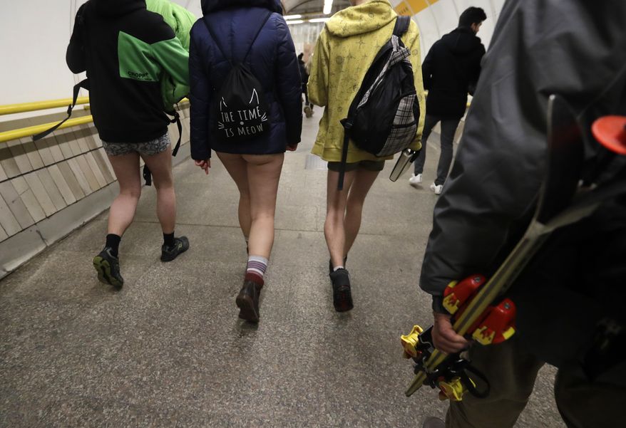 Passengers take part in the No Pants Subway Ride in Prague, Czech Republic, Sunday, Jan. 8, 2017. The No Pants Subway Ride began in 2002 in New York as a stunt and has taken place in cities around the world since then. (AP Photo/Petr David Josek)