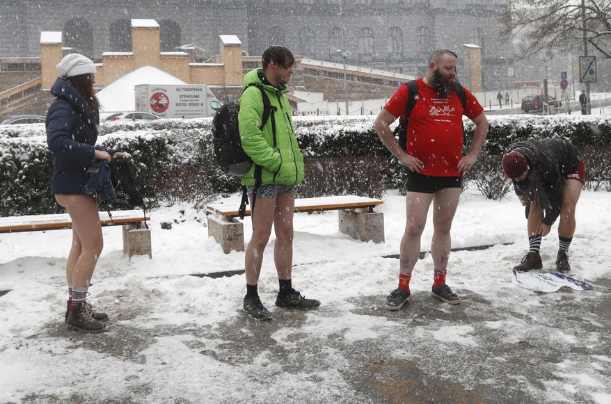 Passengers prepare to take part in the No Pants Subway Ride in Prague, Czech Republic, Sunday, Jan. 8, 2017. The No Pants Subway Ride began in 2002 in New York as a stunt and has taken place in cities around the world since then. (AP Photo/Petr David Josek)