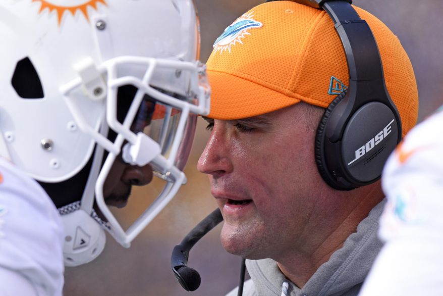 Miami Dolphins head coach Adam Gase, right, stands on the sideline during the first half of an AFC wild-card NFL football game against the Pittsburgh Steelers in Pittsburgh, Sunday, Jan. 8, 2017. (AP Photo/Don Wright)