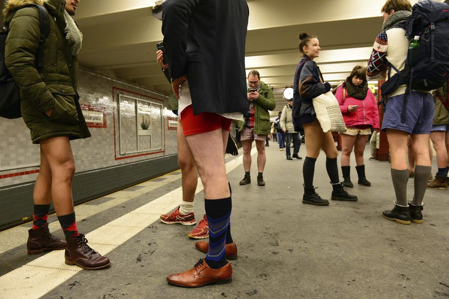 Young people with no pants wait for the subway train during the event 'No Pants Subway Ride' in Berlin, Germany, Sunday Jan. 8, 2017. What started in New York City in 2002 with a just a handful of people has blossomed into a worldwide movement involving thousands. No Pants rides are scheduled Sunday in about 50 cities across the U.S., Canada, Europe and Australia. (Maurizio Gambarini/dpa via AP)
