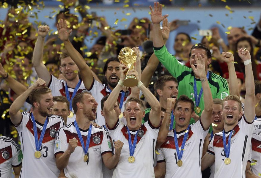 In this July 13, 2014, file photo Germany's Bastian Schweinsteiger holds up the World Cup trophy as the team celebrates their 1-0 victor over Argentina after the World Cup final soccer match between Germany and Argentina at the Maracana Stadium in Rio de Janeiro, Brazil. FIFA is about to make the World Cup a bigger and, it hopes, richer event even at the cost of lower quality soccer. FIFA President Gianni Infantino hopes his ruling Council will agree Tuesday, Jan. 10, 2017, to expand the 2026 World Cup to 48 nations, playing in 16 groups of three teams. (AP Photo/Natacha Pisarenko, file)