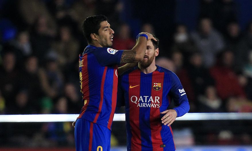 FC Barcelona's Lionel Messi, right, celebrates after scoring with his teammate Luis Suarez during the Spanish La Liga soccer match between Villarreal and Barcelona at the Ceramica stadium in Villarreal, Spain, Sunday, Jan. 8, 2017. (AP Photo/Alberto Saiz)