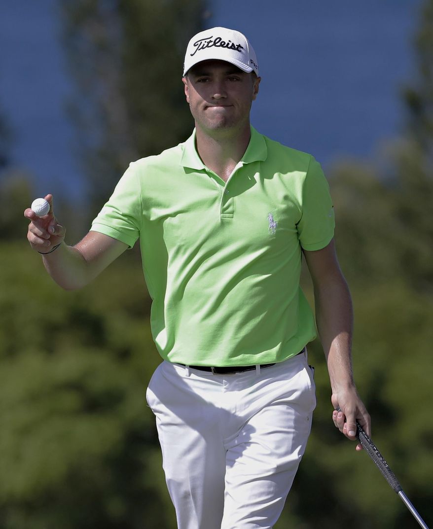 Justin Thomas waves after making birdie on the 13th green during the final round of the Tournament of Champions golf event, Sunday, Jan. 8, 2017, at Kapalua Plantation Course in Kapalua, Hawaii. (AP Photo/Matt York)