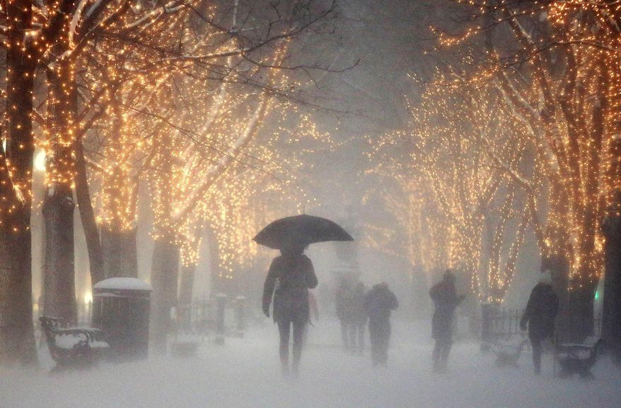 People walk through the Commonwealth Avenue Mall during a winter storm in Boston, Saturday, Jan. 7, 2017. A storm that wreaked havoc along the East Coast arrived in southern New England on Saturday, bringing blizzard conditions to some areas and making travel treacherous throughout the region. (AP Photo/Michael Dwyer)