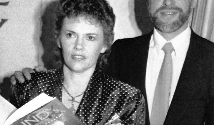 FILE - This October 1990, file photo shows Michael Chamberlain, right, and then his wife Lindy when Lindy launched her book on the disappearance of her baby daughter Azaria in 1980. Chamberlain, who waged a long battle to prove his baby daughter was killed by a dingo in Australia's most notorious case of injustice, has died, Chamberlain's ex-wife Lindy confirmed Tuesday, Jan. 10, 2017. He was 72. (AP Photo/Russell McPhadran, File)