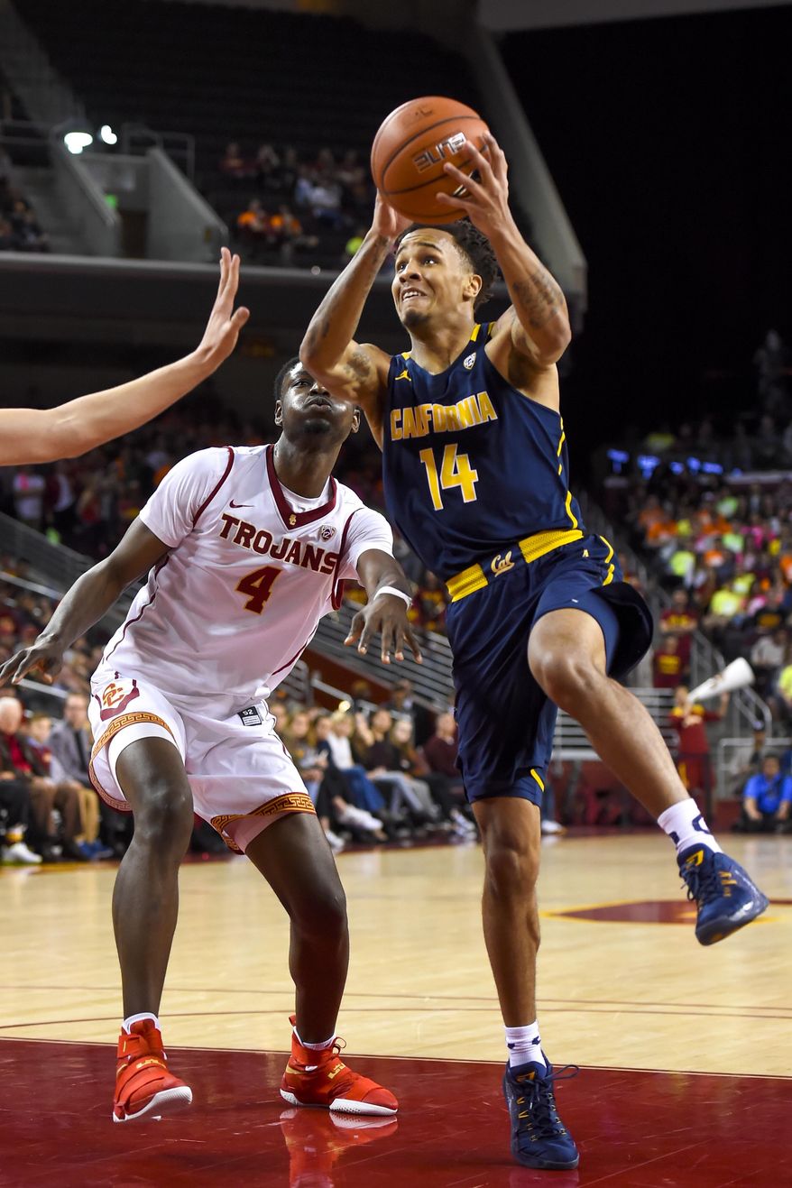 California guard Don Coleman (14) gets by Southern California forward Chimezie Metu (4) for a basket during the first half of an NCAA college basketball game, Sunday, Jan. 8, 2017, in Los Angeles. (AP Photo/Gus Ruelas)