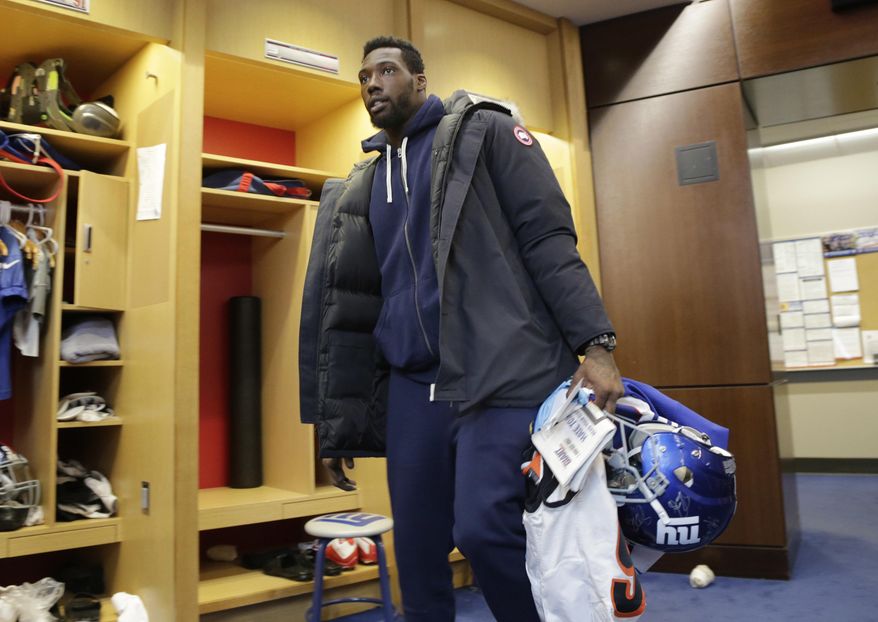 New York Giants defensive end Jason Pierre-Paul takes some of his gear out of the NFL football team&#x27;s locker room in East Rutherford, N.J., Monday, Jan. 9, 2017. (AP Photo/Seth Wenig)
