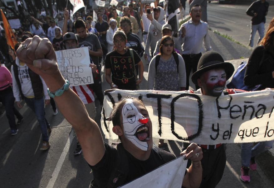 Protesters shout slogans as they march against fuel price hikes in Mexico City, Monday, Jan. 9, 2017. Largely peaceful protests against the fuel price increases continued nationwide in Mexico, and looting seen last week largely subsided. The protests have left hundreds of businesses looted and more than 1,500 detained.(AP Photo/Marco Ugarte)
