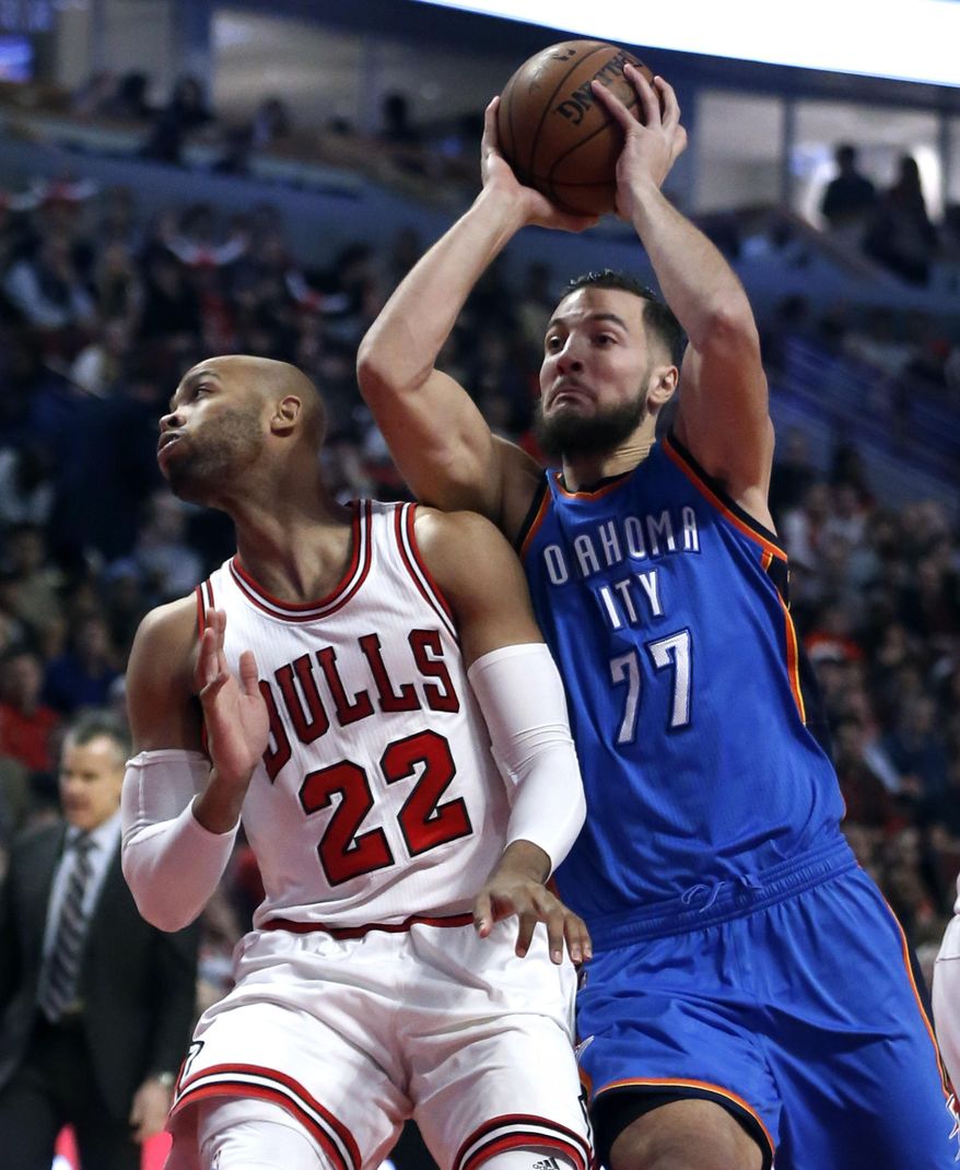 Oklahoma City Thunder's Joffrey Lauvergne (77) drives on Chicago Bulls' Taj Gibson during the first half of an NBA basketball game Monday, Jan. 9, 2017, in Chicago. (AP Photo/Charles Rex Arbogast)