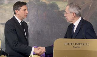 Austrian President elect Alexander van der Bellen, right, shakes hands with Slovenian President Borut Pahor, left, in Vienna, Austria, Tuesday, Jan. 10, 2017. (AP Photo/Ronald Zak) **FILE**