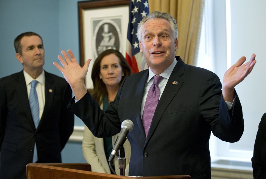 Virginia Gov. Terry McAuliffe, right, gestures during a news conference as his wife, Dorothy and Lt. Gov. Ralph Northam, left, listen at the Capitol in Richmond, Va., Tuesday, Jan. 10, 2017. McAuliffe detailed his ethics reform legislative package. (AP Photo/Steve Helber)