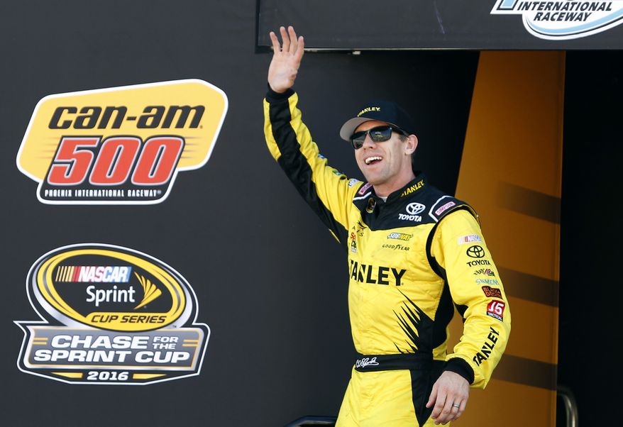 FILE - In this Nov. 13, 2016, file photo, Carl Edwards waves during driver introductions for the NASCAR Sprint Cup Series auto race at Phoenix International Raceway in Avondale, Ariz. Two people with knowledge of the situation tell The Associated Press that NASCAR driver Carl Edwards is retiring. Joe Gibbs Racing has scheduled a pair of news conferences Wednesday. Jan. 11, 2017, in which Edwards is expected to announce he is giving up the sport immediately. (AP Photo/Ralph Freso, File)