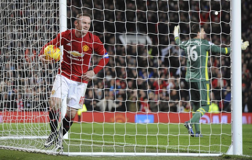Manchester United's Wayne Rooney smiles as he collects the ball from the back of the net after teammate Manchester United's Juan Mata scored the opening goal of the match during the English League Cup semifinal, 1st leg, soccer match between Manchester United and Hull at Old Trafford stadium in Manchester, England, Tuesday, Jan. 10, 2017. (AP Photo/Rui Vieira)