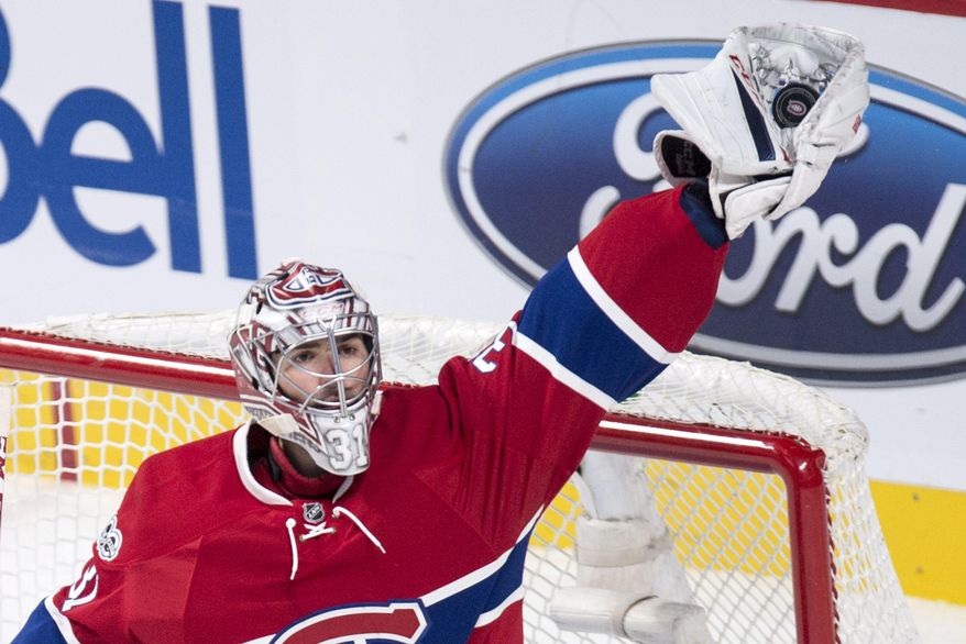 Montreal Canadiens goalie Carey Price reaches out to snag the pack against the Washington Capitals during the third period of an NHL hockey game Monday, Jan. 9, 2017, in Montreal. (Paul Chiasson/The Canadian Press via AP)