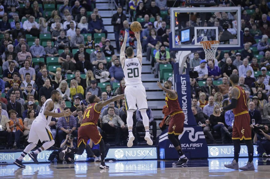 Utah Jazz forward Gordon Hayward (20) shoots as Cleveland Cavaliers guard DeAndre Liggins (14) defends in the first half during an NBA basketball game Tuesday, Jan. 10, 2017, in Salt Lake City. (AP Photo/Rick Bowmer)