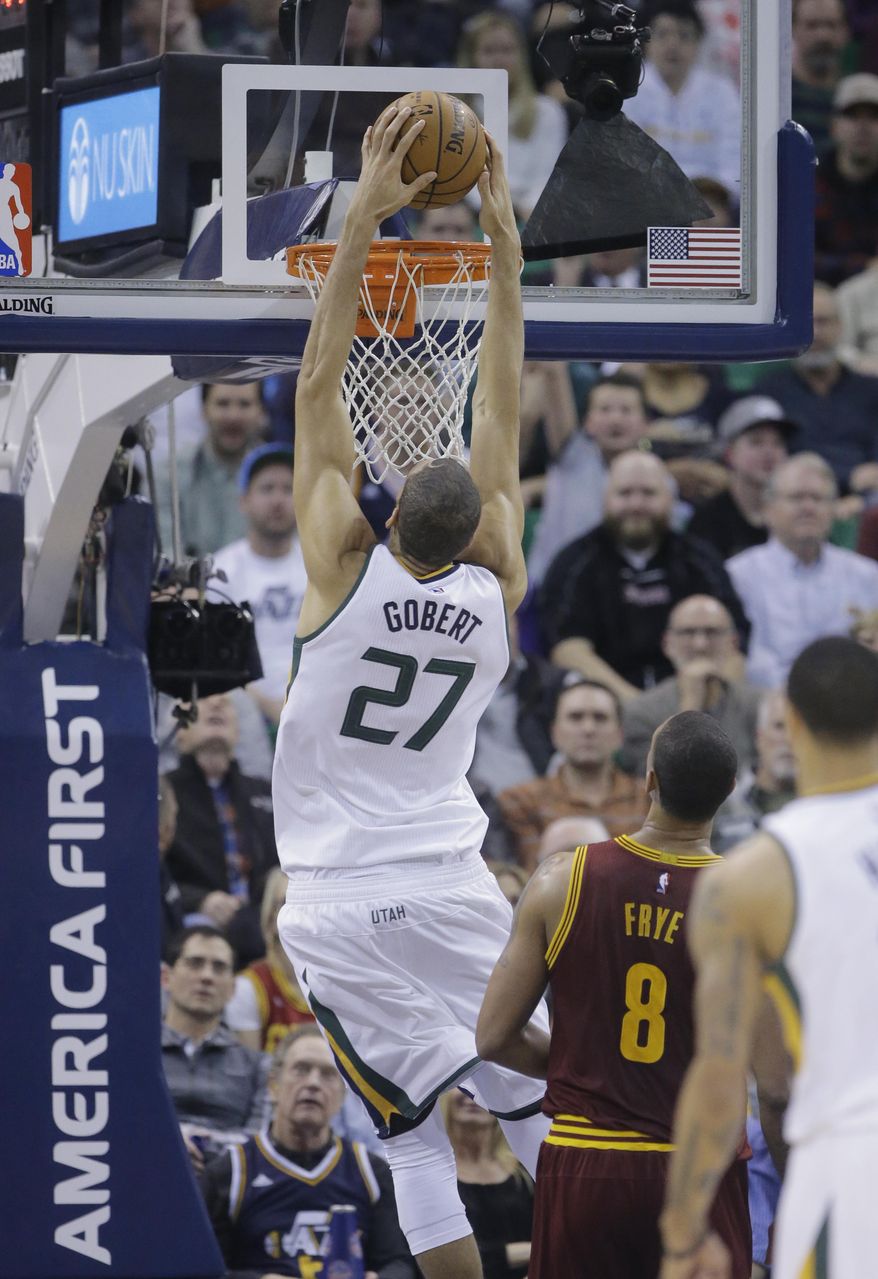 Utah Jazz center Rudy Gobert (27) dunks the ball as Cleveland Cavaliers forward Channing Frye (8) looks on in the first half during an NBA basketball game Tuesday, Jan. 10, 2017, in Salt Lake City. (AP Photo/Rick Bowmer)