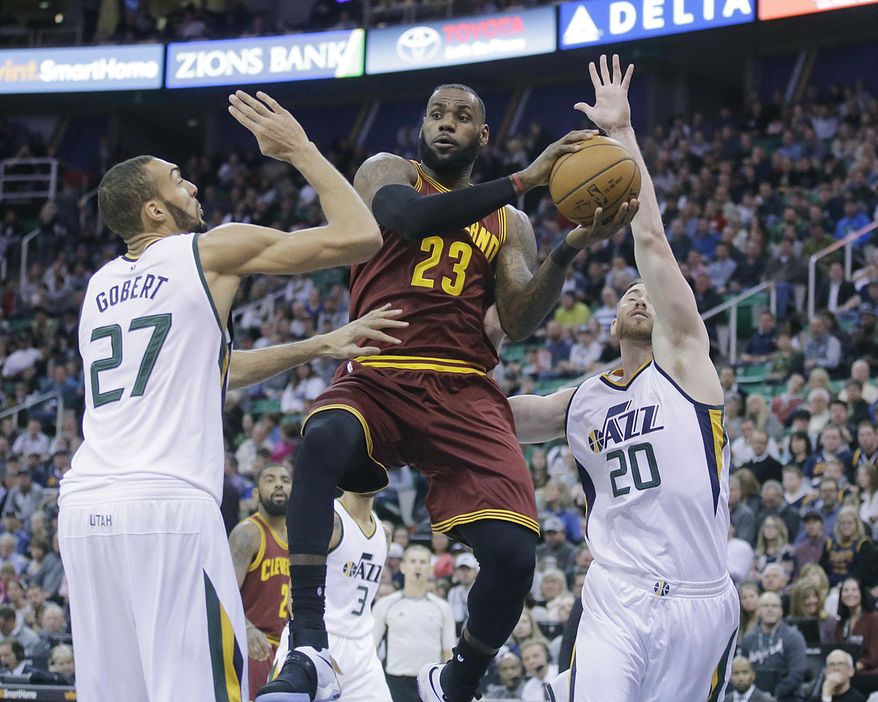 Cleveland Cavaliers forward LeBron James (23) passes the ball as Utah Jazz's Rudy Gobert (27) and Gordon Hayward (20) defend in the first half during an NBA basketball game Tuesday, Jan. 10, 2017, in Salt Lake City. (AP Photo/Rick Bowmer)