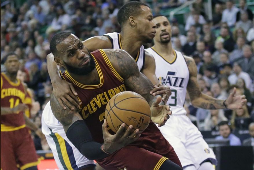 Utah Jazz guard Rodney Hood, rear, fouls Cleveland Cavaliers forward LeBron James, left, as he goes to the basket in the first half during an NBA basketball game Tuesday, Jan. 10, 2017, in Salt Lake City. (AP Photo/Rick Bowmer)