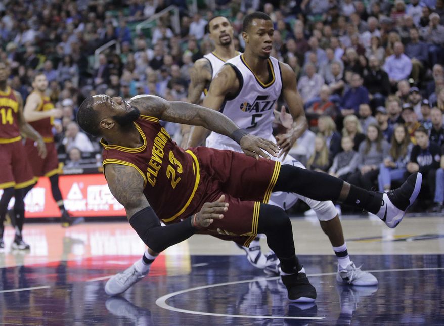 Utah Jazz guard Rodney Hood, rear, fouls Cleveland Cavaliers forward LeBron James (23) as he shoots in the first half during an NBA basketball game Tuesday, Jan. 10, 2017, in Salt Lake City. (AP Photo/Rick Bowmer)
