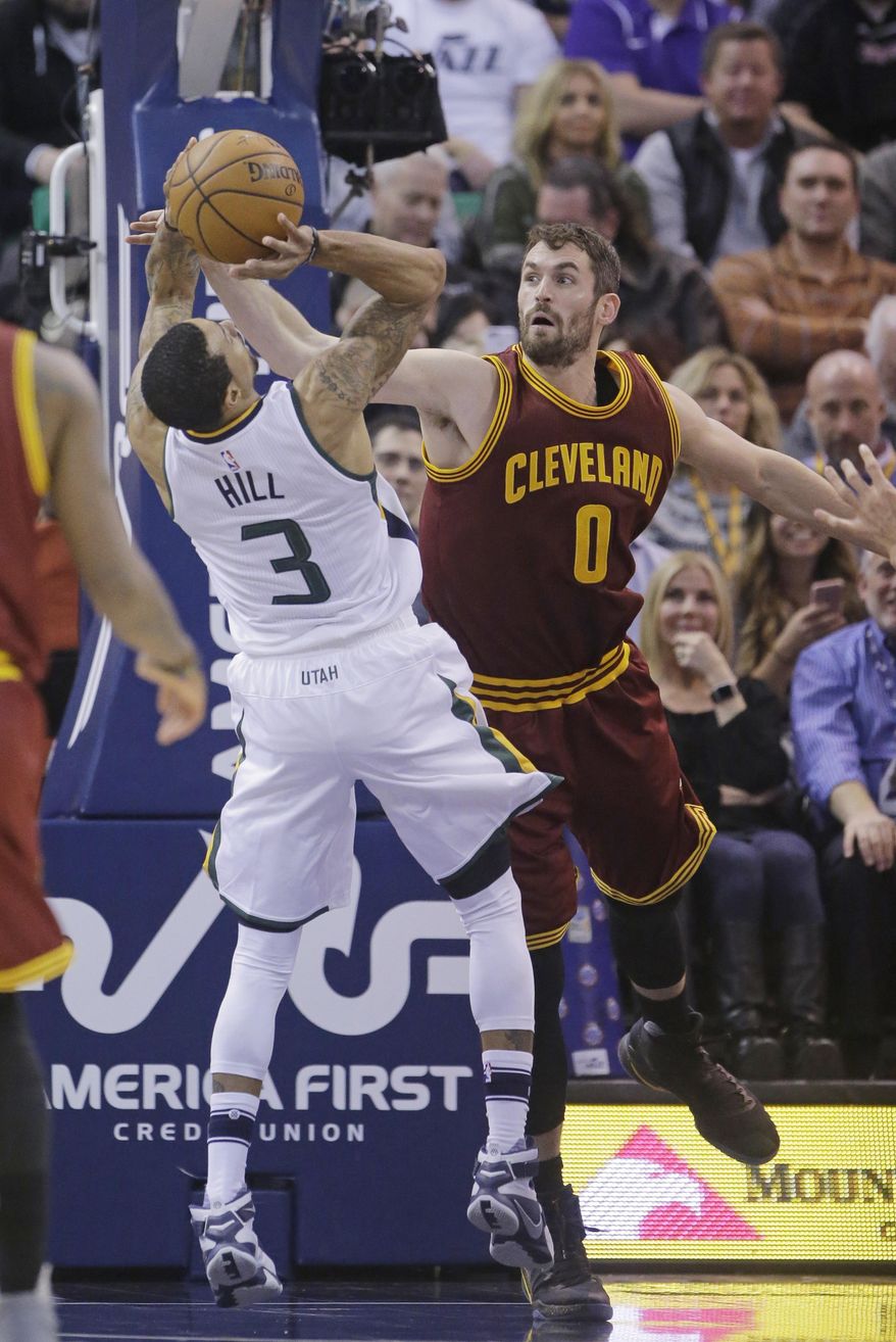 Utah Jazz guard George Hill (3) shoots as Cleveland Cavaliers forward Kevin Love (0) defends in the first half during an NBA basketball game Tuesday, Jan. 10, 2017, in Salt Lake City. (AP Photo/Rick Bowmer)