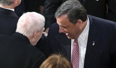New Jersey Gov. Chris Christie, right, greets former Gov. Brendan Byrne, as he arrives in the Assembly chamber of the Statehouse to deliver his State Of The State address Tuesday, Jan. 10, 2017, in Trenton, N.J. (AP Photo/Mel Evans)
