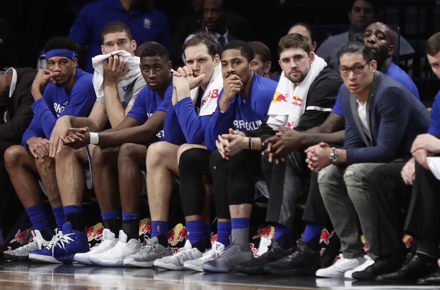 Brooklyn Nets' Brook Lopez, second from left, and Jeremy Lin, right, watch with teammates during the second half of the team's NBA basketball game against the Atlanta Hawks on Tuesday, Jan. 10, 2017, in New York. The Hawks won 117-97. (AP Photo/Frank Franklin II)