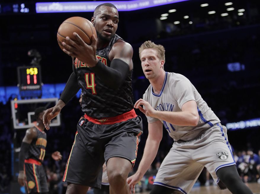 Brooklyn Nets' Justin Hamilton (41) defends Atlanta Hawks' Paul Millsap (4) during the second half of an NBA basketball game Tuesday, Jan. 10, 2017, in New York. The Hawks won 117-97. (AP Photo/Frank Franklin II)
