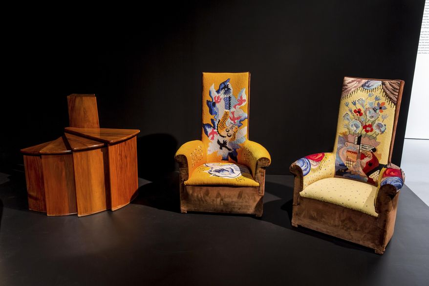 This undated photo provided by the Jewish Museum shows two Peirre Chareau designed high-backed chauffeuses (fireside armchairs), wood and velours, with tapestry upholstery by Jean Lurçat, and reupholstered in 1968, in an installation view of the exhibition "Pierre Chareau: Modern Architecture and Design," in New York. (Will Ragozino/The Jewish Museum via AP)