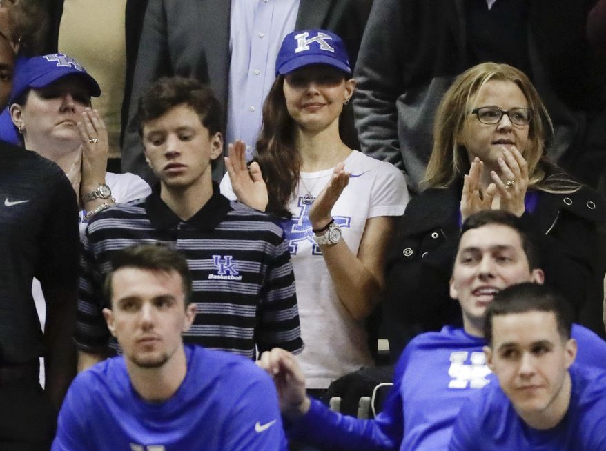 Actress and Kentucky fan Ashley Judd, center, cheers from behind the team bench during the second half of Kentucky's NCAA college basketball game against Vanderbilt on Tuesday, Jan. 10, 2017, in Nashville, Tenn. Kentucky won 87-81. (AP Photo/Mark Humphrey)
