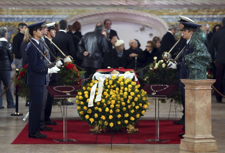 Soldiers from the Portuguese Air Force, Army and Navy stand by the casket of former prime minister and president of Portugal Mario Soares who lies in state at Lisbon's Jeronimos monastery Monday, Jan. 9 2017. Soares, who helped steer his country toward democracy after a 1974 military coup, died Saturday aged 92. A state funeral will be held Tuesday. (AP Photo/Armando Franca)