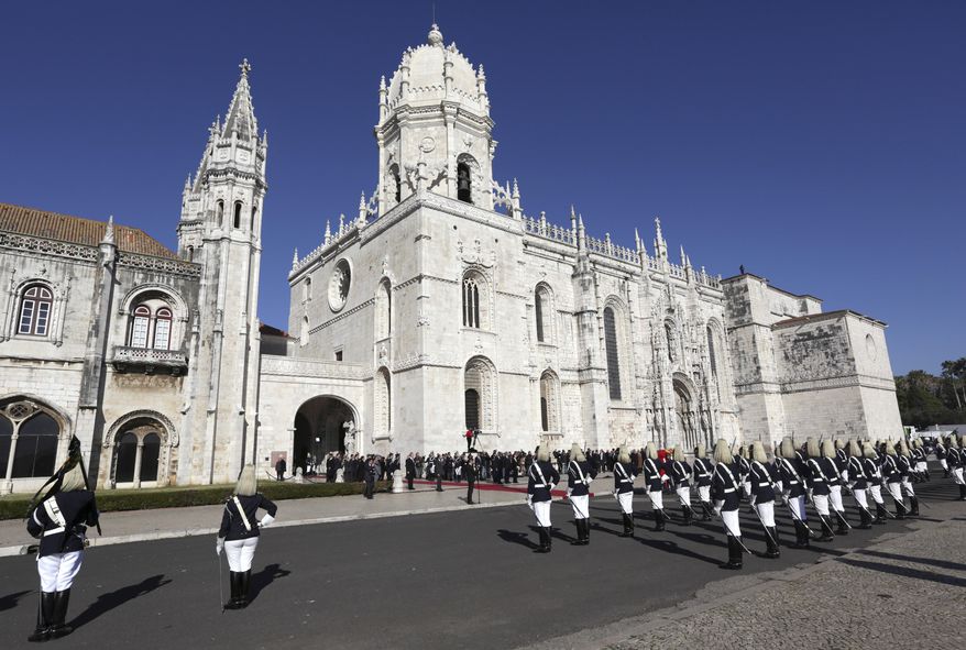 The honor guard stands outside Lisbon's Jeronimos monastery on Monday, Jan. 9 2017, as the casket of former prime minister and president of Portugal Mario Soares arrives to lie in state. Soares, who helped steer his country toward democracy after a 1974 military coup, died Saturday aged 92. A state funeral will be held Tuesday. (AP Photo/Armando Franca)