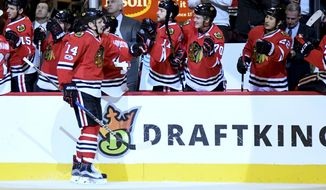 Chicago Blackhawks left wing Richard Panik (14) celebrates his goal against the Detroit Red Wings with teammates during the first period of an NHL hockey game on Tuesday, Jan. 10, 2017, in Chicago. (AP Photo/Matt Marton)