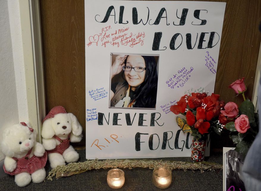 In this Saturday, Jan. 7, 2017, photo, a prayer vigil in honor of Jamie Lee Wounded Arrow at the Cleveland Heights apartment building in Sioux Falls, S.D. Police say a man accused of fatally stabbing the transgender woman in Sioux Falls has been charged with murder and other counts. (Jay Pickthorn/The Argus Leader via AP)