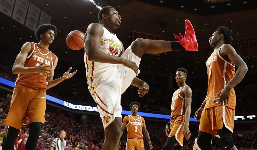 Iowa State guard Deonte Burton, center, reacts after dunking the ball during the second half of an NCAA college basketball game against Texas, Saturday, Jan. 7, 2017, in Ames, Iowa. (AP Photo/Charlie Neibergall)