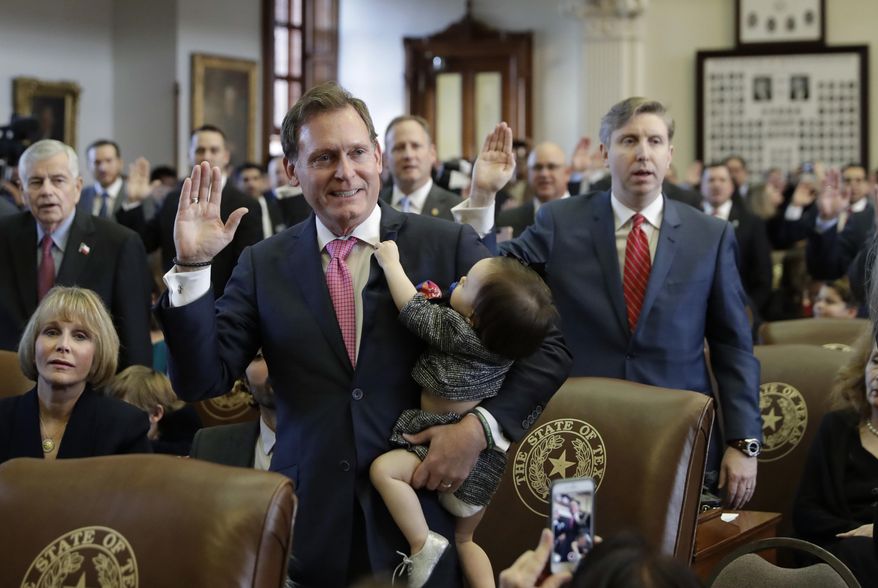 Texas Rep. John Zerwas,R-Katy, holds his granddaughter, Tinley, as he and other lawmakers are sworn in during the beginning of the 85th Texas Legislative session at the Texas State Capitol Tuesday, Jan. 10, 2017, in Austin, Texas. (AP Photo/Eric Gay)
